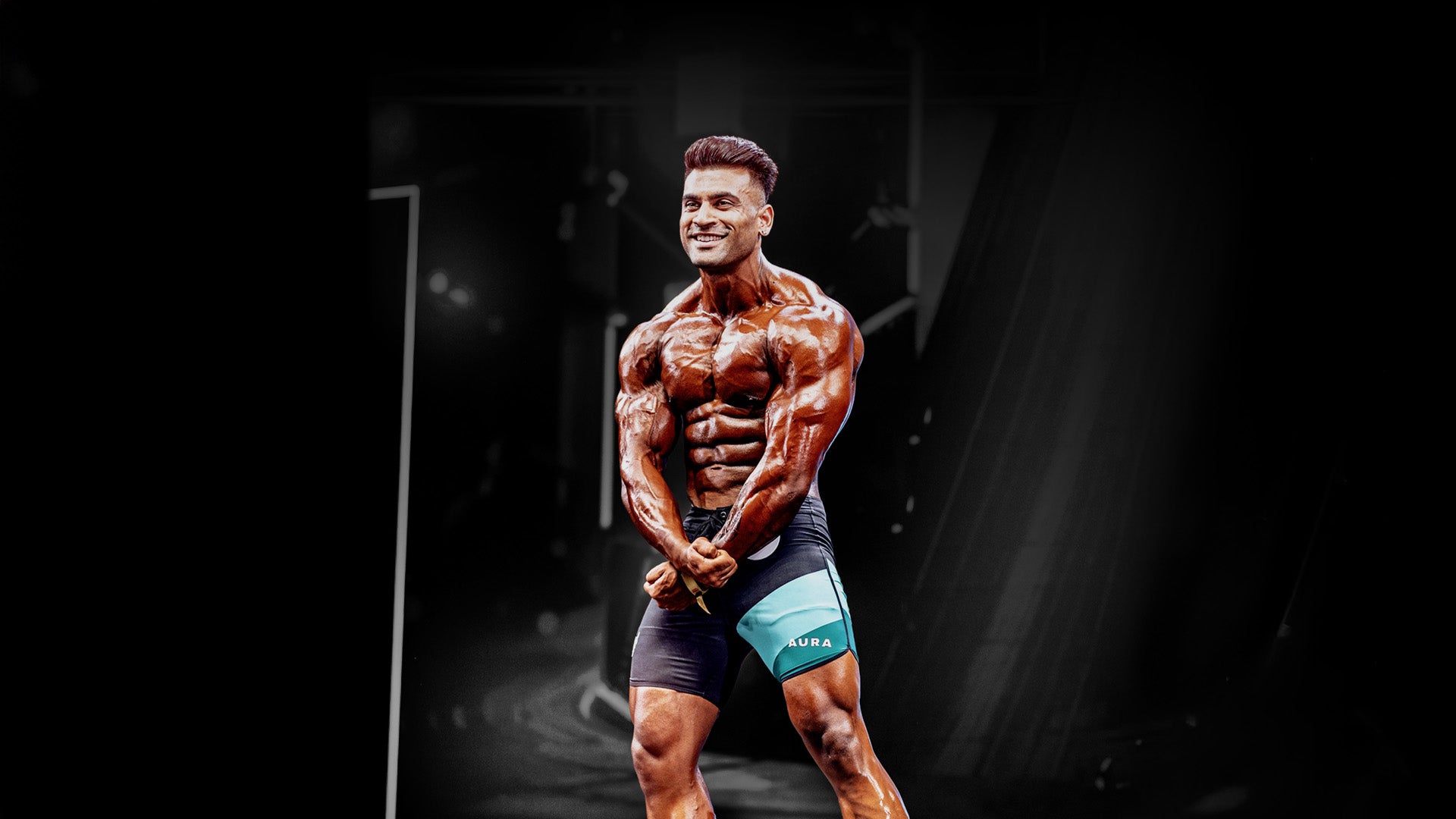 Muscular man posing in a dark indoor setting